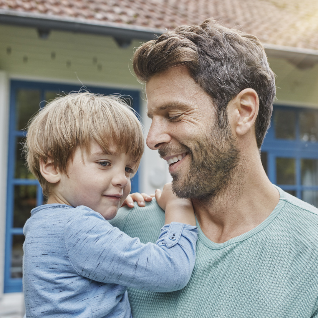 father holding young son